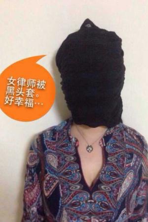 Online performance art campaign initiated by women human rights defenders to protest the thug-like treatment of lawyer Wang Shengsheng. Placards read: &quot;Women lawyers in black hoods, where is the light?&quot;