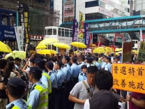 Police separate democracy protesters from supporters of electoral reform package, at the &quot;The Citizens Against Pseudo-Universal Suffrage&quot; march, Hong Kong, June 14, 2015. HRIC photo.