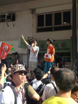 Joshua Wong and another Scholarism member talk to participants in the democracy march organized by Civil Human Rights Front, from Victoria Park to Tim Mei Avenue, Hong Kong, July 1, 2015. HRIC photo.