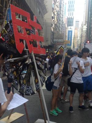 Sign: “Democracy,” during the democracy march organized by Civil Human Rights Front, Hong Kong, July 1, 2015. HRIC photo.
